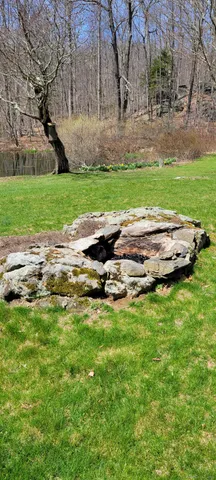 a view of a house with a yard and sitting area