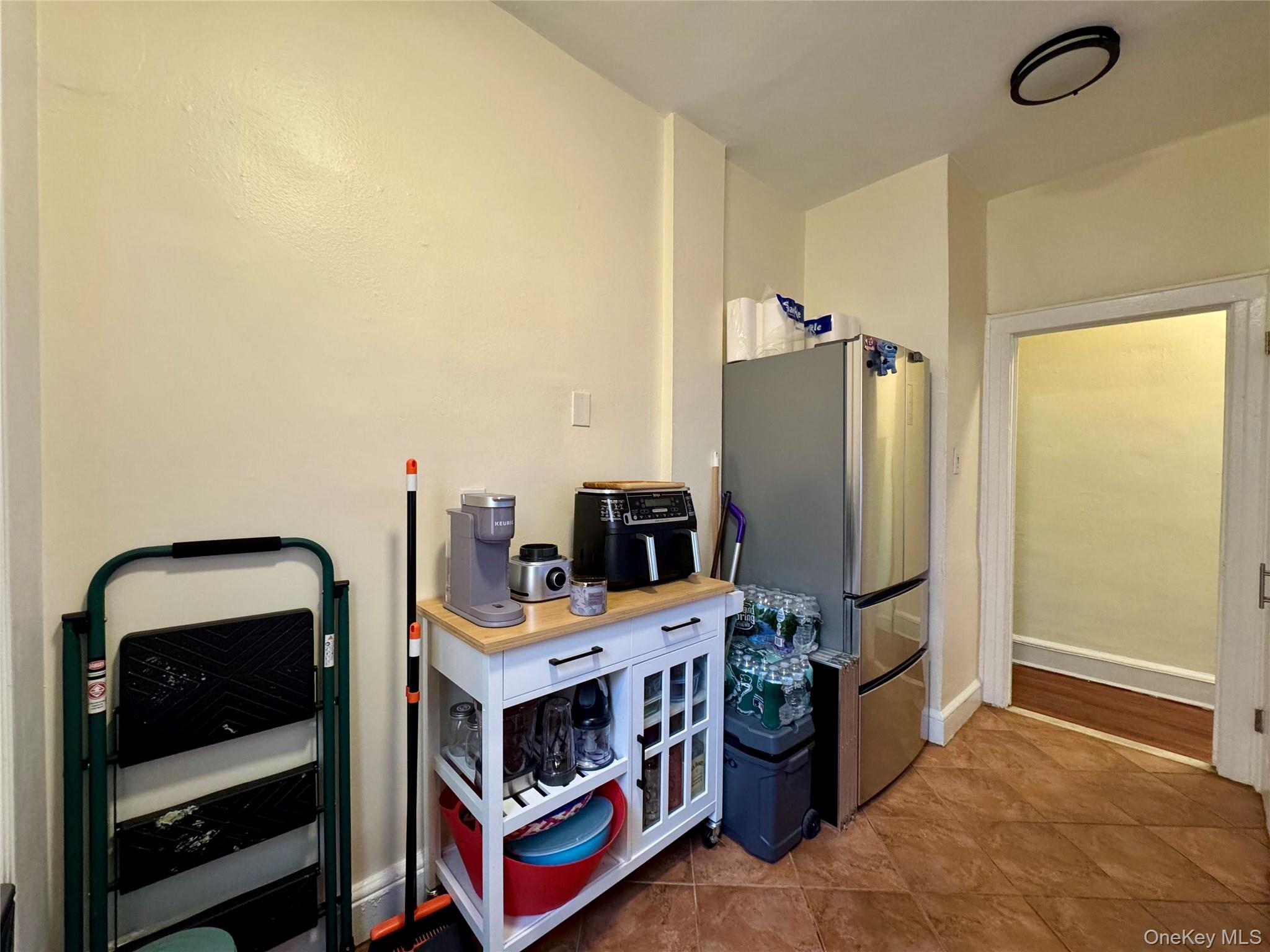 83-64 Talbot Street, Unit 3A Queens, NY 11415 - Photo 2 of 19 Kitchen featuring freestanding refrigerator and tile patterned flooring