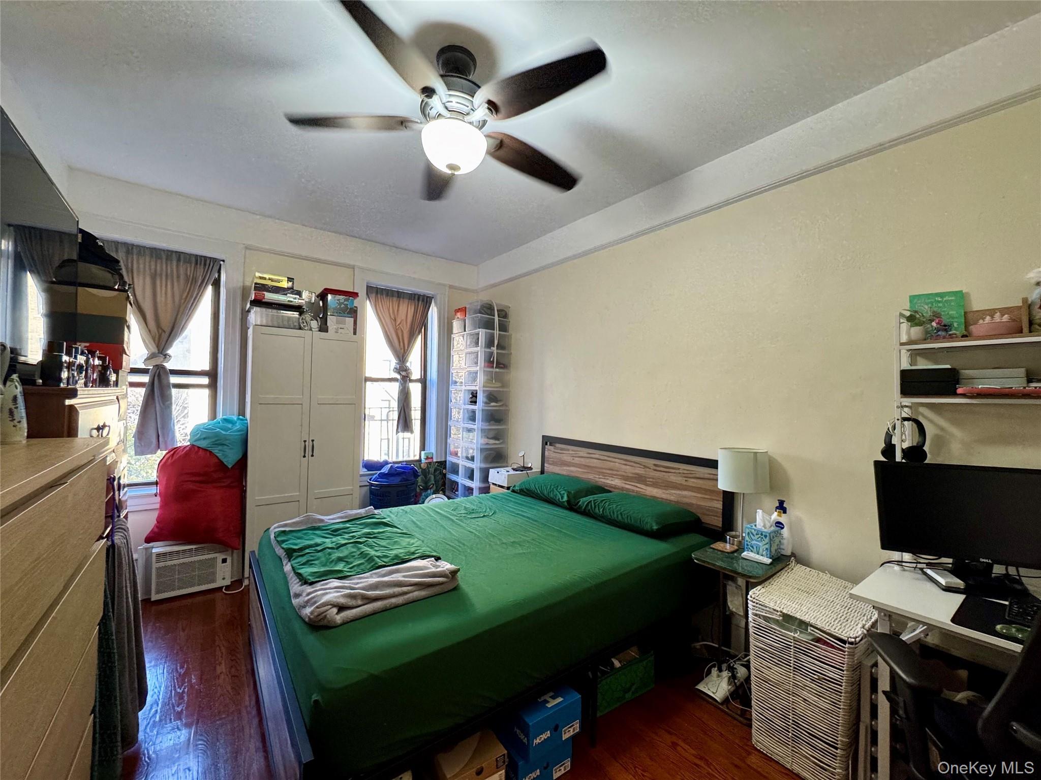 83-64 Talbot Street, Unit 3A Queens, NY 11415 - Photo 5 of 19 Bedroom featuring dark wood-style flooring and ceiling fan