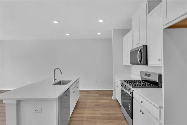 a kitchen with a sink and a stove top oven