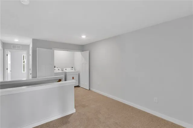 a view of an empty room with window and cabinet