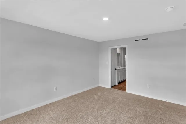 a spacious bathroom with a granite countertop sink mirror and double