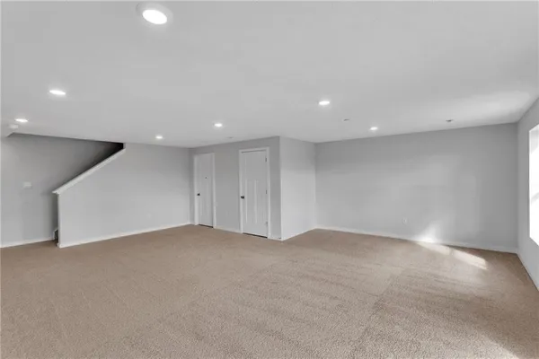 an empty room with a projector and white walls