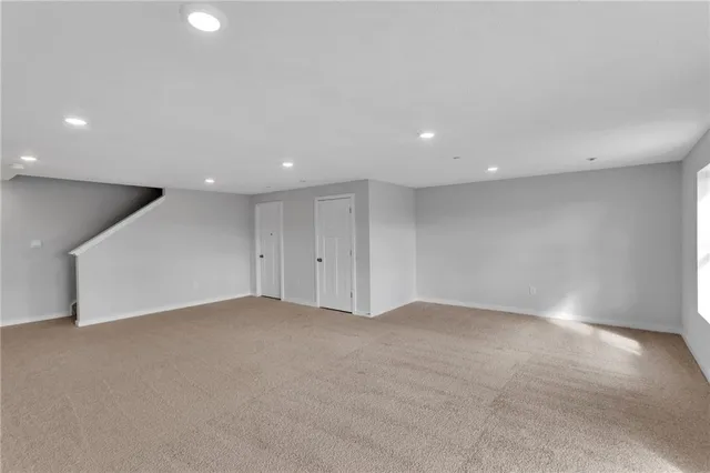 an empty room with a projector and white walls