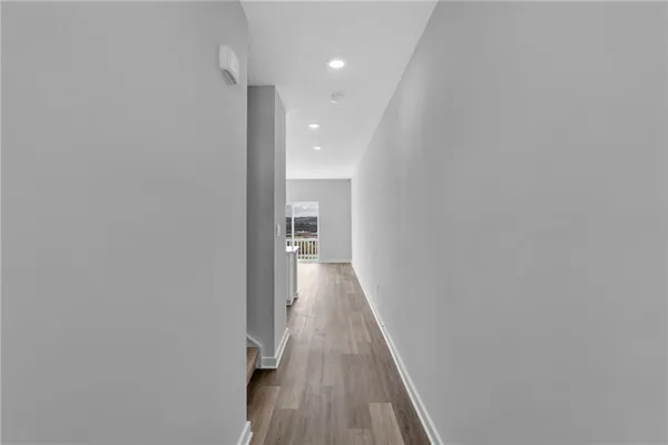 a view of a hallway with wooden floor
