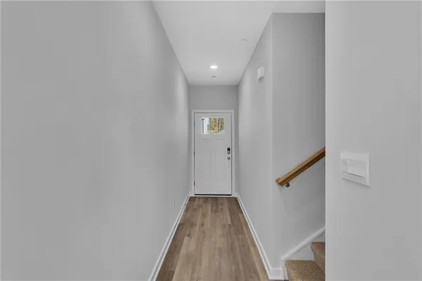 a view of a hallway with wooden floor
