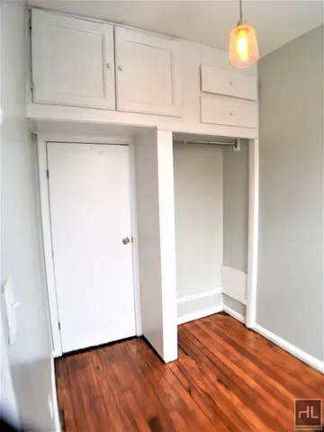 a view of room with wooden floor