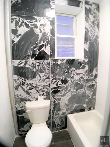 a bathroom with a toilet and a shower curtain