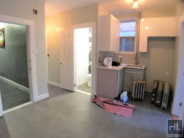 an empty room with furniture and a mirror