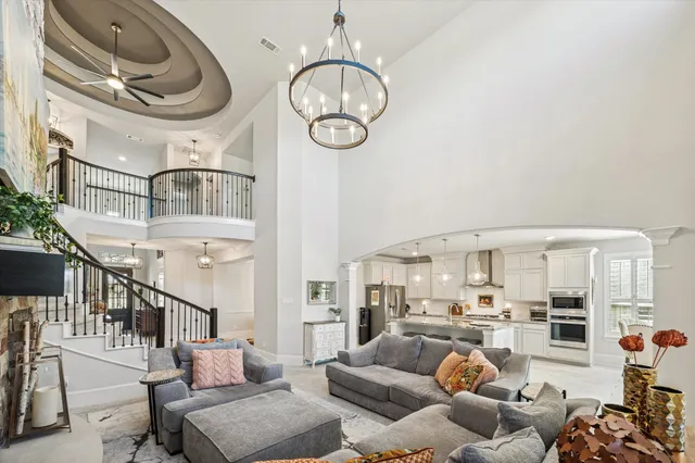 a living room with furniture a rug and a chandelier