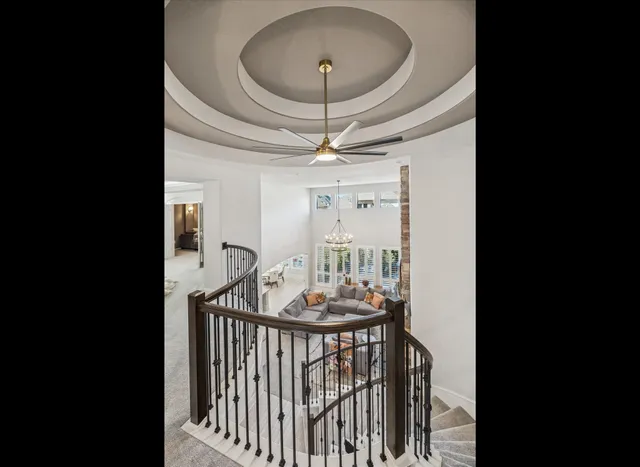 a view of a hallway and a livingroom with furniture