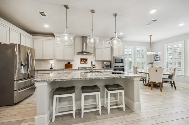 a large kitchen with cabinets and stainless steel appliances