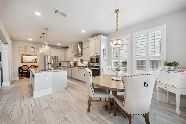 a large kitchen with a table and chairs