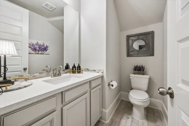 a bathroom with a toilet a sink and mirror