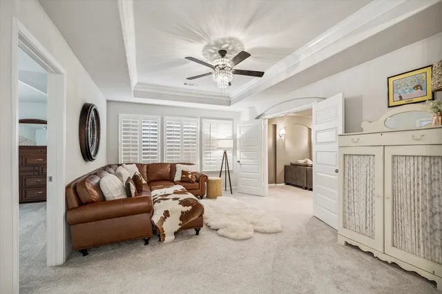 a bedroom with furniture and a large window