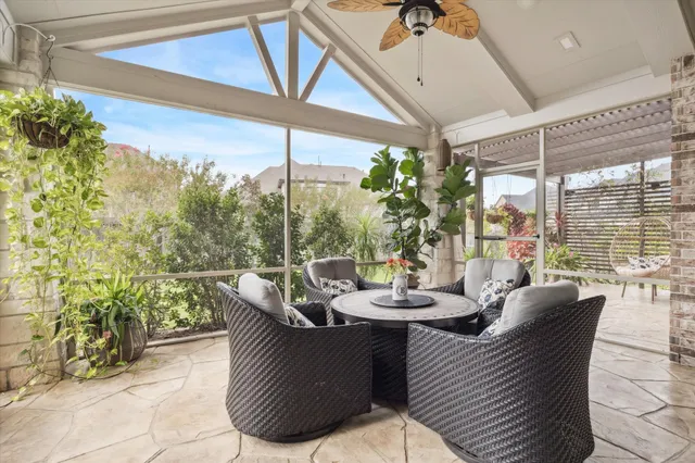 a dining room with furniture and a floor to ceiling window