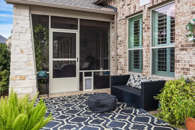 a view of a house with a couches and potted plant