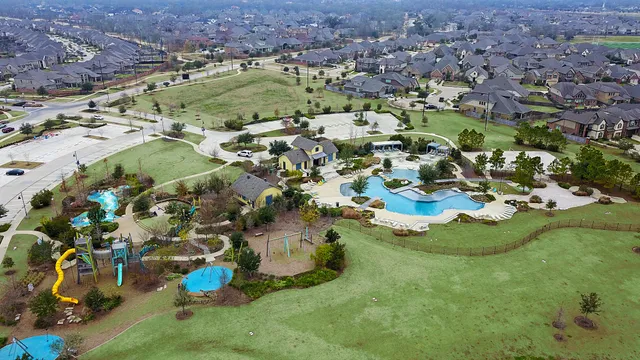 an aerial view of residential houses with outdoor space