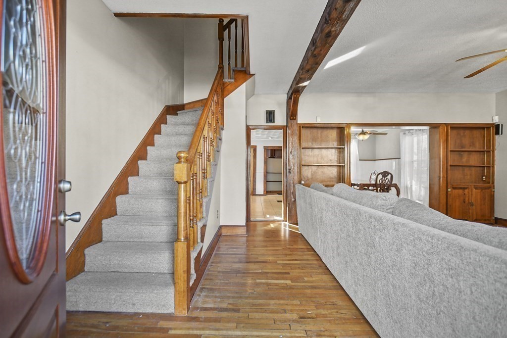 242 Eastern Avenue Lynn, MA 01902 - Photo 12 of 23 a view of a living room with wooden floor and stairs