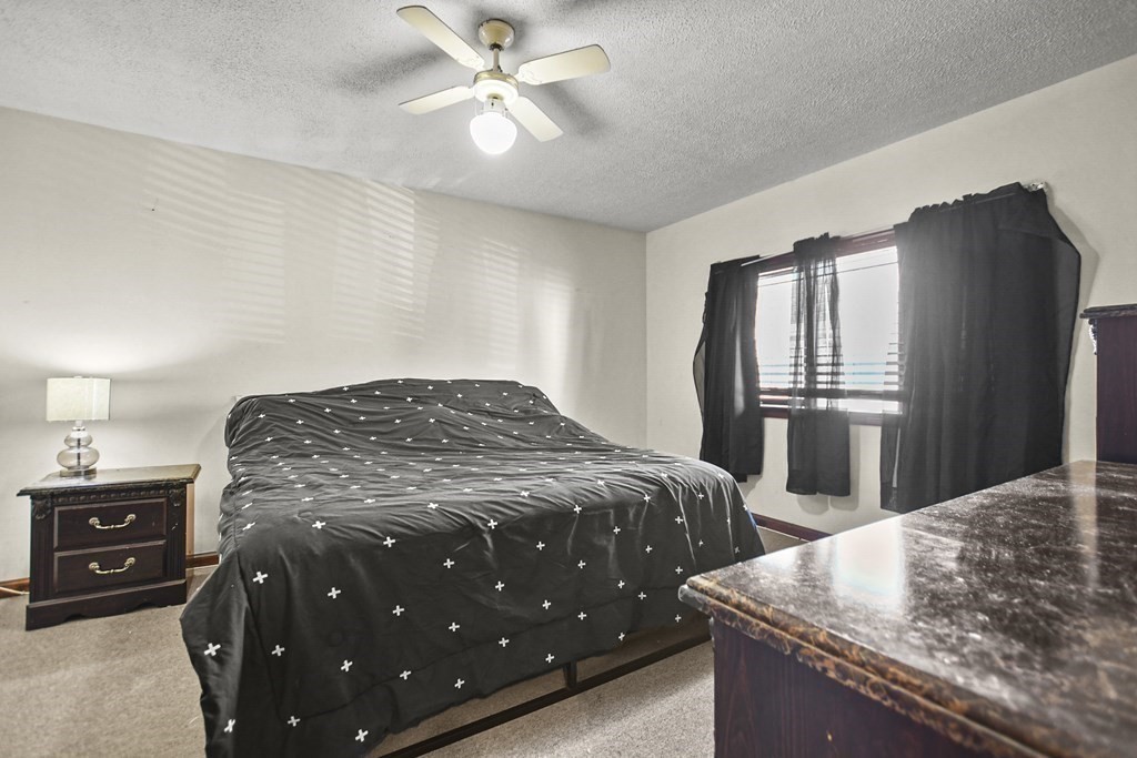 242 Eastern Avenue Lynn, MA 01902 - Photo 15 of 23 a bedroom with a bed and wooden floor