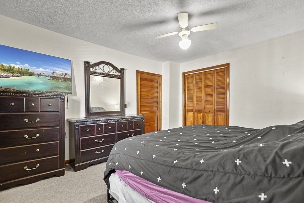 242 Eastern Avenue Lynn, MA 01902 - Photo 17 of 23 a bedroom with a large bed and a large window