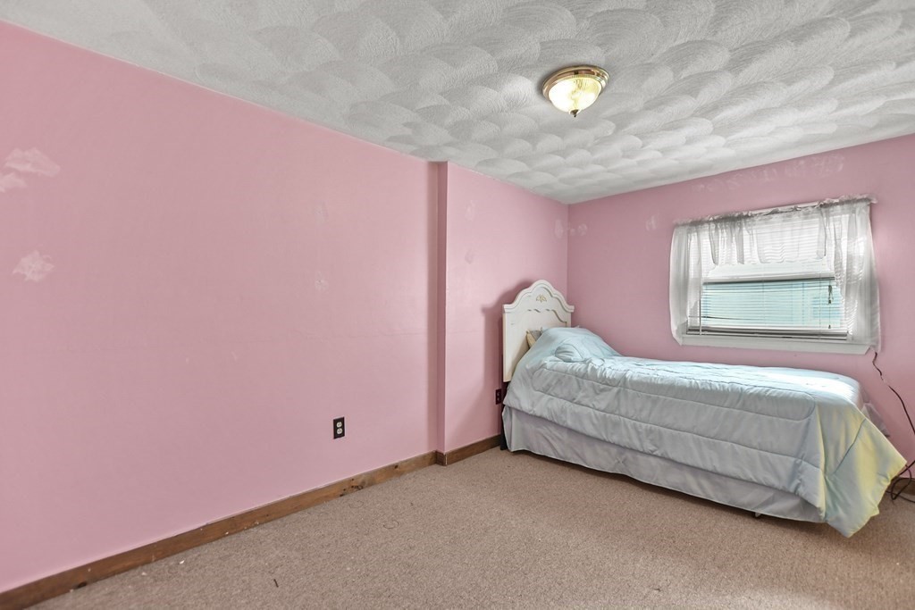 242 Eastern Avenue Lynn, MA 01902 - Photo 22 of 23 a bedroom with a bed and a window