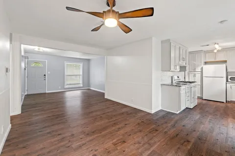 a view of a kitchen with wooden floor and a kitchen