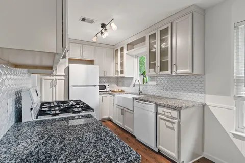 a kitchen with a sink stove and refrigerator