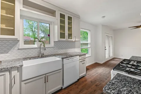 a kitchen with a sink stove and cabinets