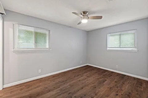 a view of a room with wooden floor and windows