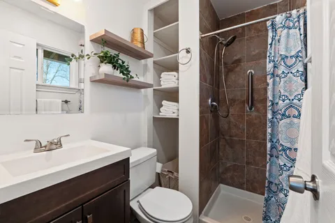 a bathroom with a sink toilet and shower