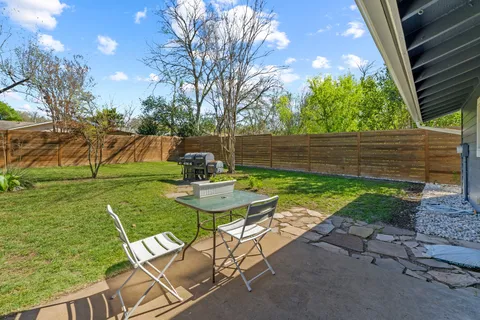 a view of backyard with seating area and green space