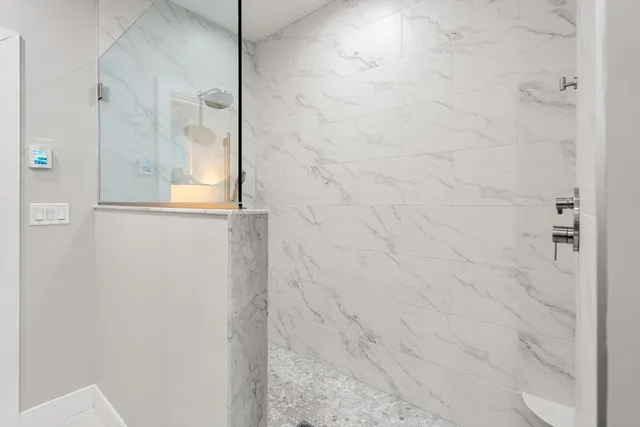 a bedroom with a bed and a dresser next to a window