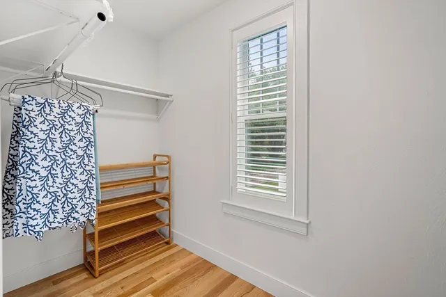 an aerial view of a house with swimming pool and trees in the background