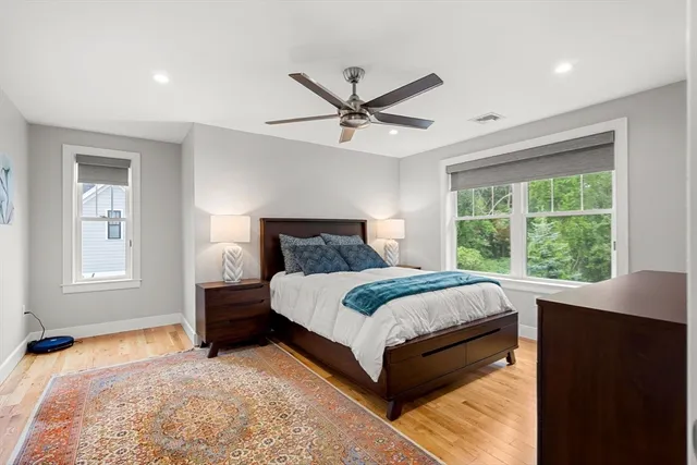 a view of backyard with wooden fence and large trees