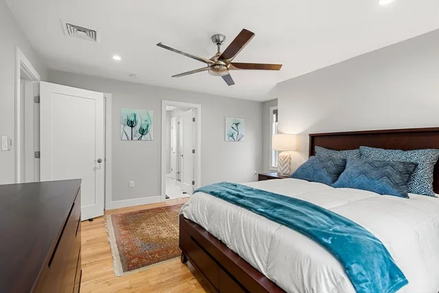a spacious bedroom with a bed and a chandelier