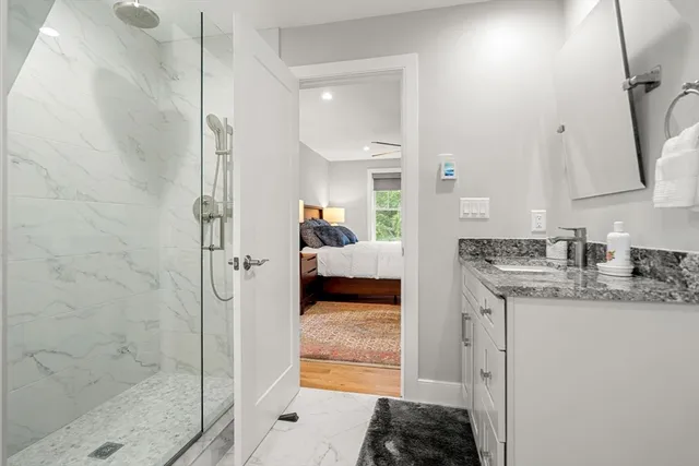 an aerial view of residential houses with outdoor space and trees