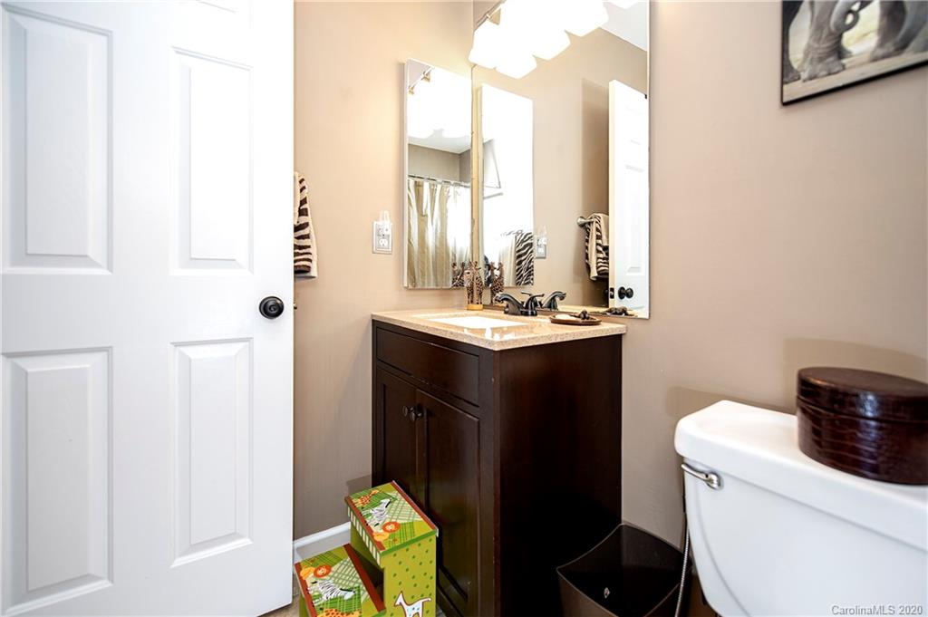305 Brixham Place Fort Mill, SC 29708 - Photo 22 of 33 a bathroom with a sink a toilet and a mirror