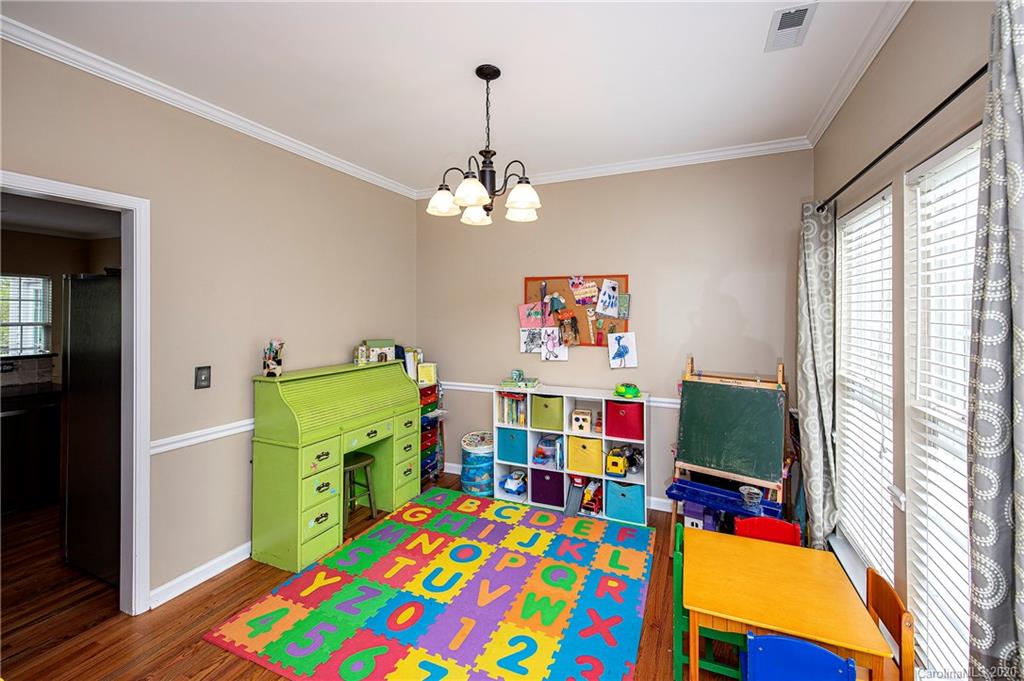 305 Brixham Place Fort Mill, SC 29708 - Photo 8 of 33 a bedroom with a bed and a baby crib