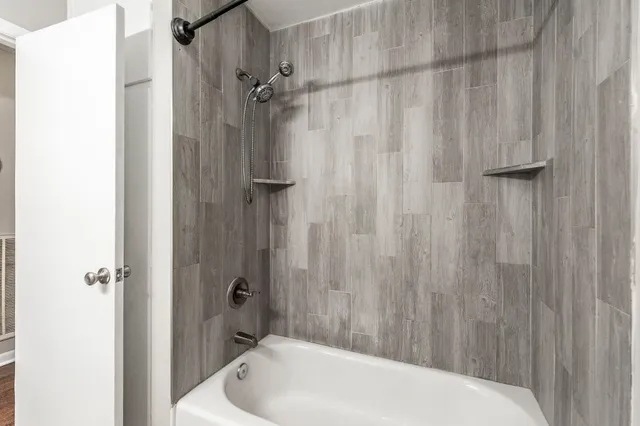 a bathroom with a shower and a sink