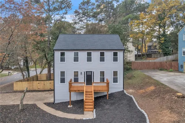 a view of house with a yard