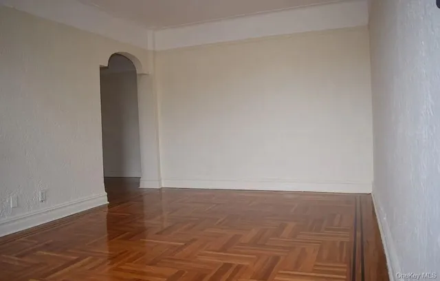 a view of an empty room and wooden floor