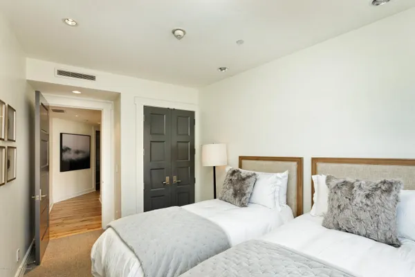 a bedroom with a bed and glass walk in closet