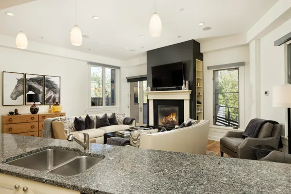 a living room with fireplace furniture and a flat screen tv