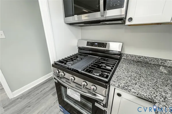 a stove top oven sitting inside of a kitchen