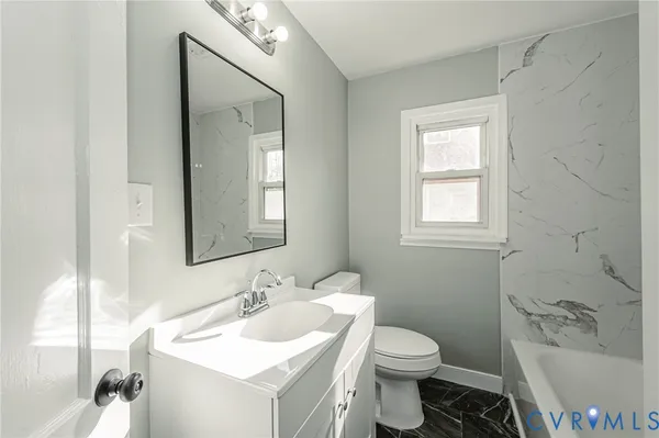 a bathroom with a sink toilet and a mirror