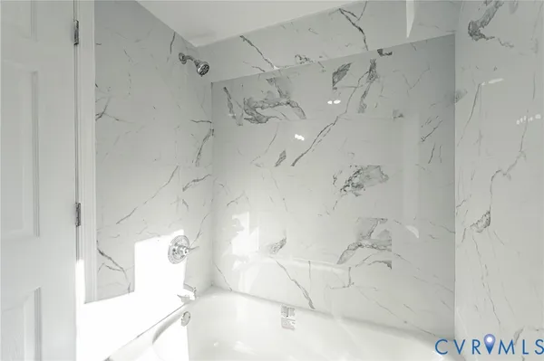 a bathroom with a bathtub and shower