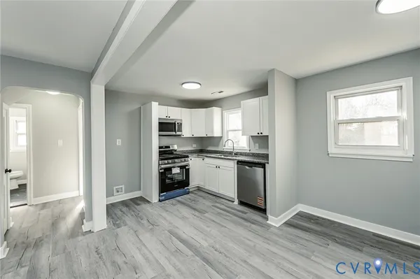 a kitchen with a refrigerator and a stove top oven