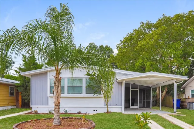 a front view of a house with a garden