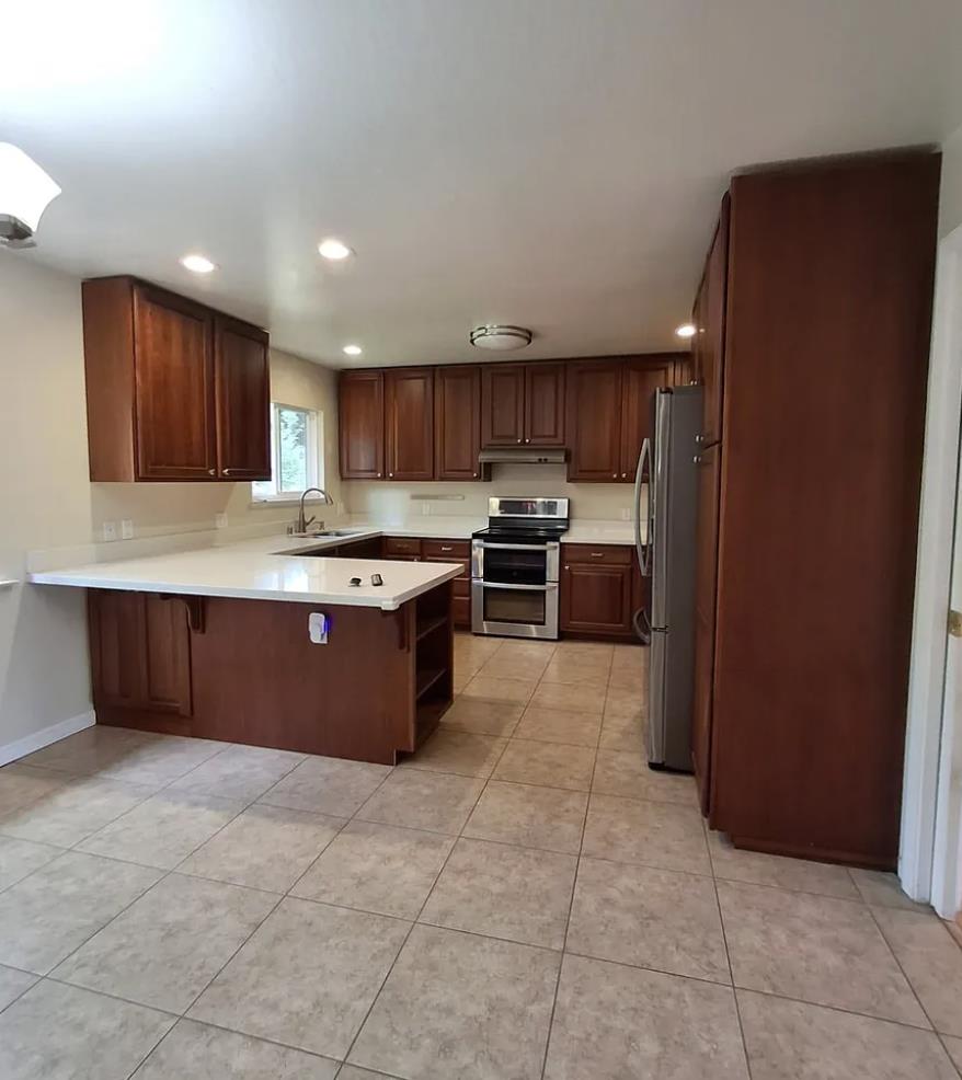 2273 Beckham Way Hayward, CA 94541 - Photo 2 of 11 a kitchen with stainless steel appliances granite countertop a stove top oven a sink and a refrigerator